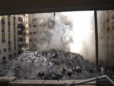 Палестинцы осматривают развалины здания после израильского авиаудара в городе Газа. Фото: Fatima Shbair / AP Photo